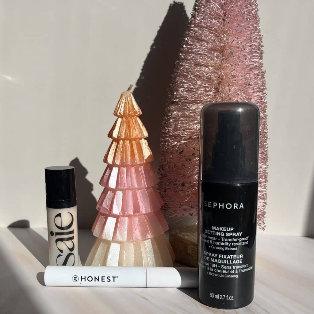 Makeup products in front of Christmas trees 