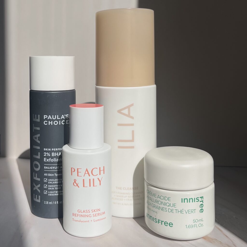 Assortment of skincare products including cleanser, exfoliant, serum, and moisturizer