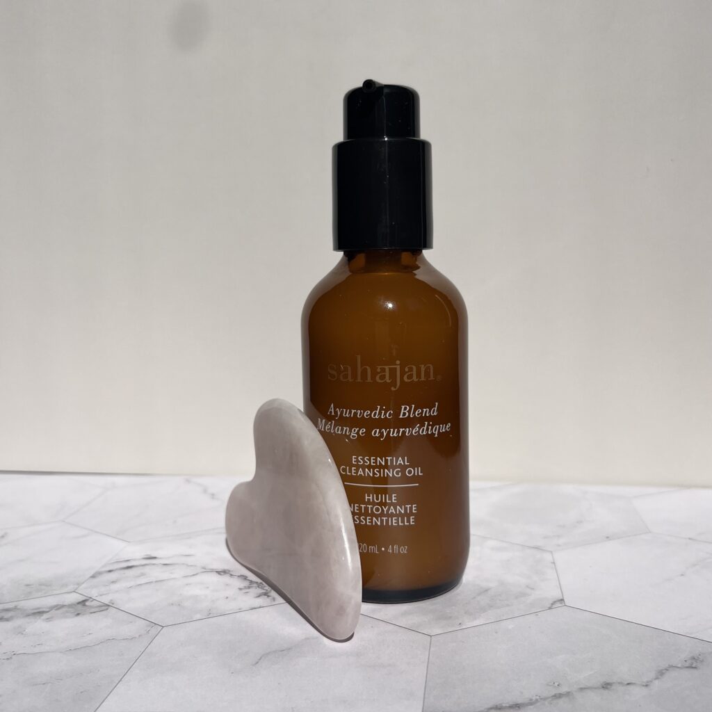 Face cleansing oil with a rose quartz Gua Sha 