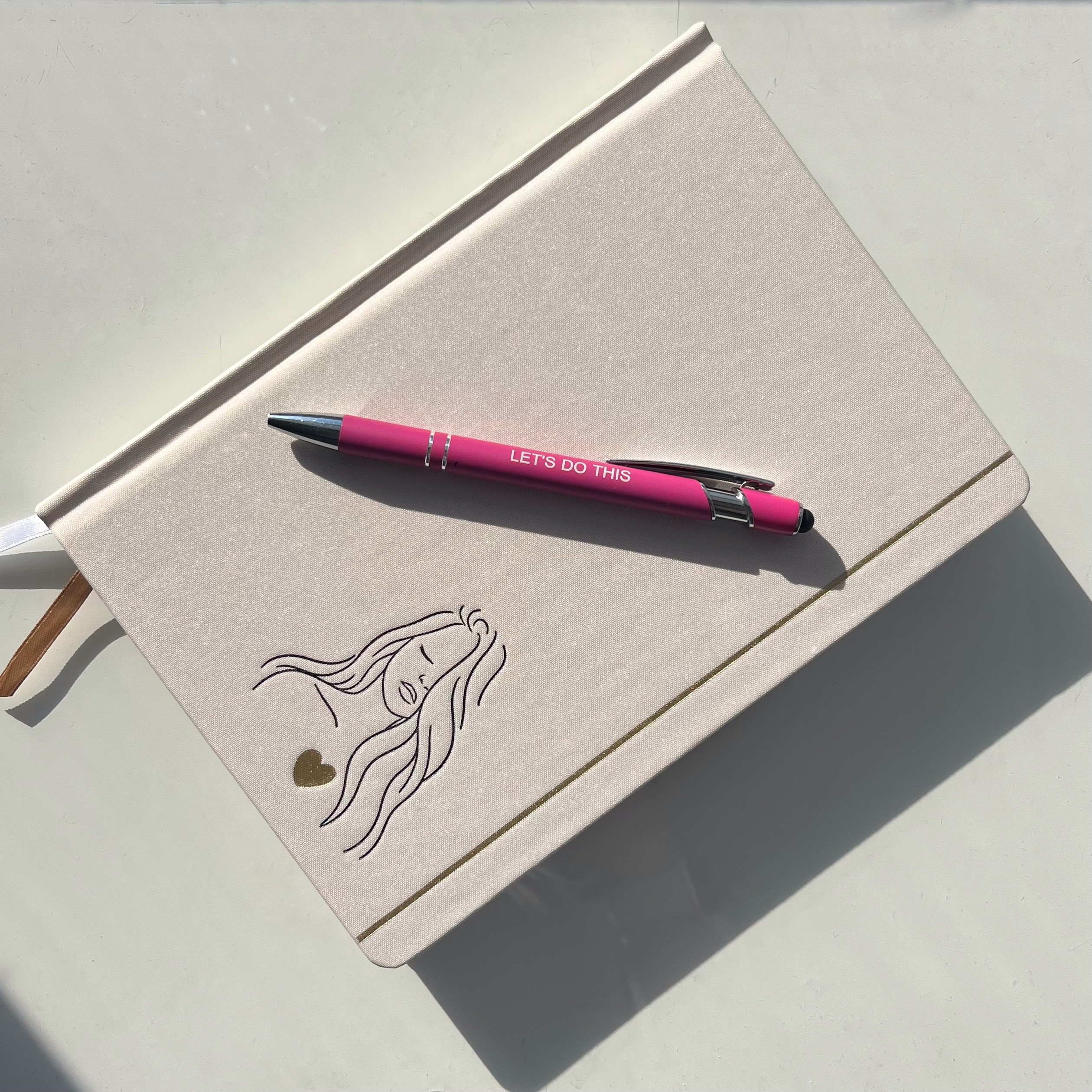 Journal with a pen that says "Let's do this"